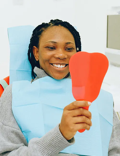 woman at the dentist looking in the mirror