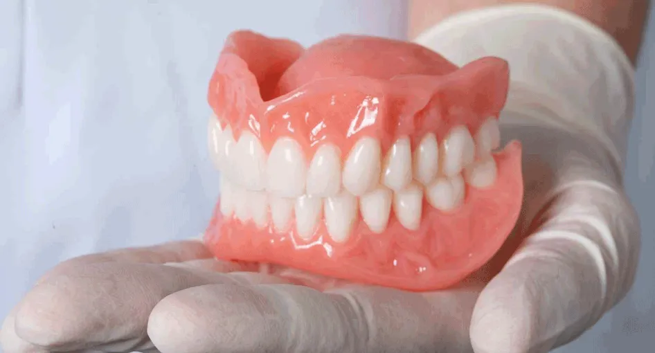 hand holding dentures inhand
