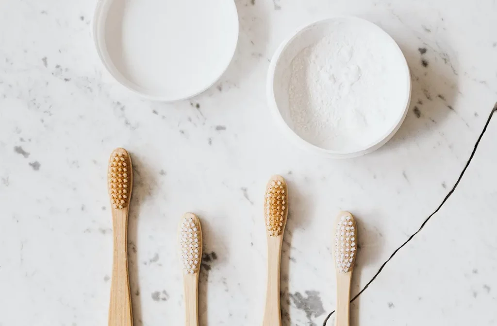4 tooth brushes and bicarbonate of soda container