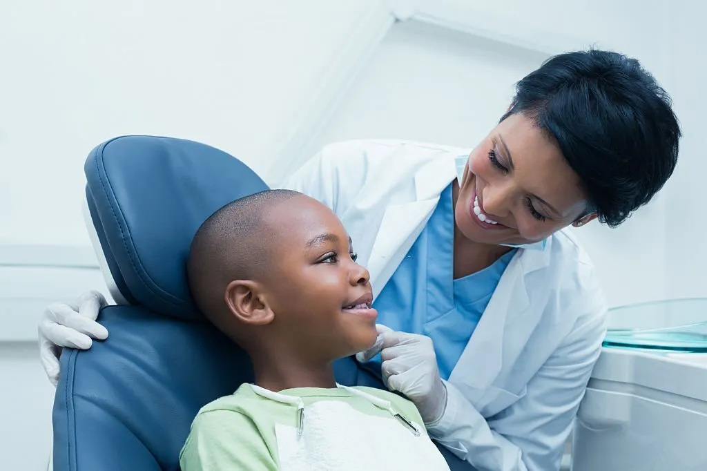 Doctor talking to a kid at the dentist