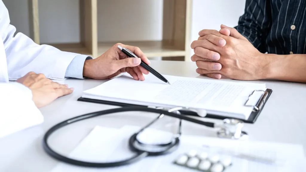 white dentist talking to white patient